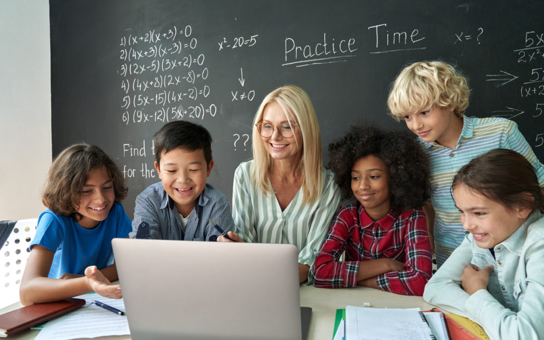 Students gathered by computer using technology in math classroom